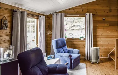 a living room with two blue chairs and a window at Stunning Home In Førde I Hordaland in Lier
