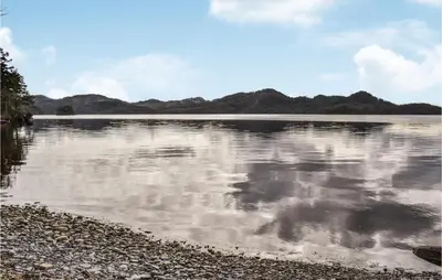 a large body of water with mountains in the background at Stunning Home In Førde I Hordaland in Lier