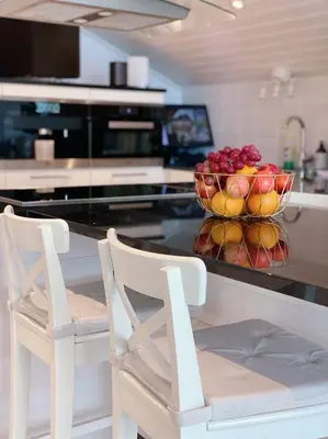 a kitchen with a bowl of fruit on a counter at Villa Arboretet - Seaside villa with private pool & infrared sauna in the heart of Arboretet, Bergen in Bergen