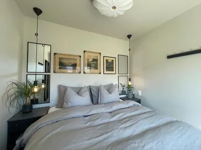 a bedroom with a white bed with a white ceiling at Studio Leilighet, nyoppusset in Langevåg