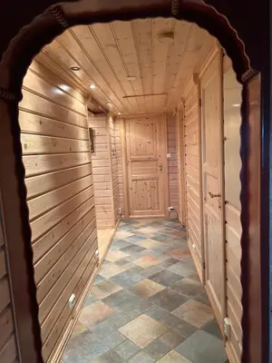 a walk in closet with wooden walls and a tile floor at Perlen på solheim I Hyen in Vereide