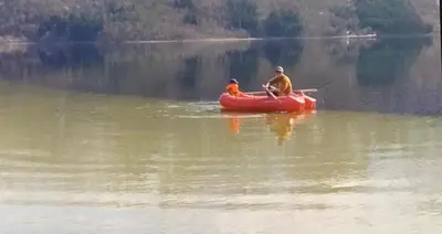 two people in a red boat on a lake at Perlen på solheim I Hyen in Vereide