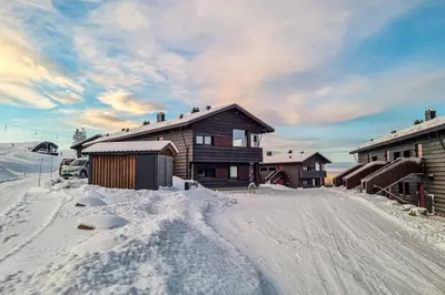 a house with snow on the ground in front of it at New ap The Nest in Hafjell ski in out and fast Wifi in Øyer
