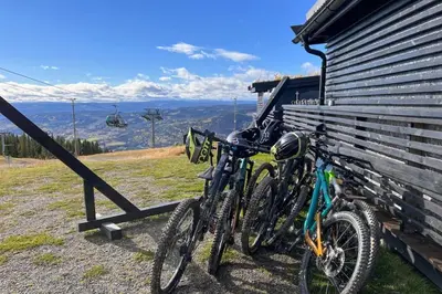 two bikes parked on the side of a house at New ap The Nest in Hafjell ski in out and fast Wifi in Øyer