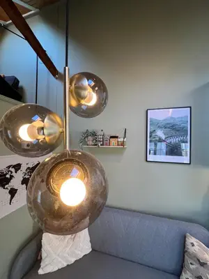 aendant light hanging over a couch in a living room at Cozy backyard apartment in Trondheim