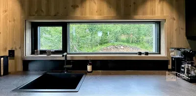 a kitchen with a sink and a window at Brand new cabin on the sunny side of Gaustatoppen with a beautiful view in Tuddal