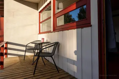 a table and two chairs on a porch with a window at Øiseth Hotell AS in Rendalen