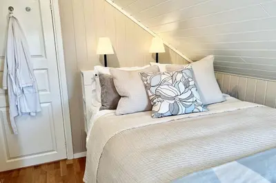 a bed with pillows on it in a bedroom at Hardangerfjord View - luxury fjord-side holiday home in Øystese