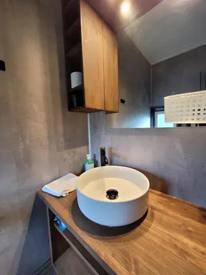 a bathroom with a white sink on a wooden counter at Friends & Family Apartment at Hafjell Alpinlandsby/Øyer Center in Hafjell