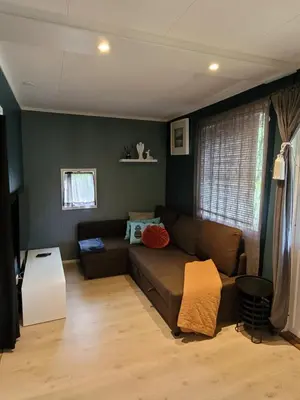 a living room with a couch and a table at Friends & Family Apartment at Hafjell Alpinlandsby/Øyer Center in Hafjell