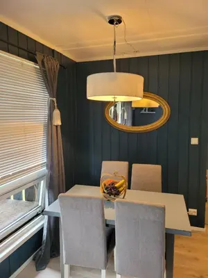 a dining table with chairs and a bowl of fruit on it at Friends & Family Apartment at Hafjell Alpinlandsby/Øyer Center in Hafjell