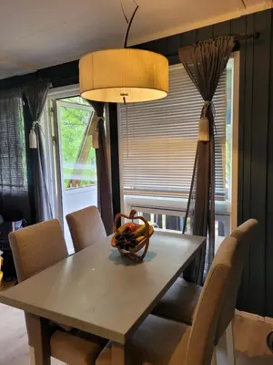 a dining room table with chairs and a lamp at Friends & Family Apartment at Hafjell Alpinlandsby/Øyer Center in Hafjell