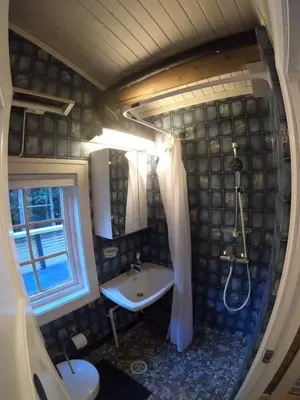 a bathroom with a sink and a shower and a tub at Gaulabua - cozy cabin by the river Gaula in Haltdalen