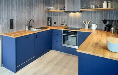 a blue kitchen with a sink and a stove at Awesome Home In Rauland With Sauna in Rauland