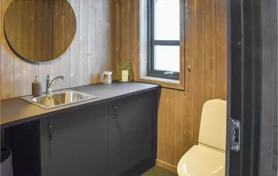 a bathroom with a sink and a toilet at Awesome Home In Rauland With Sauna in Rauland
