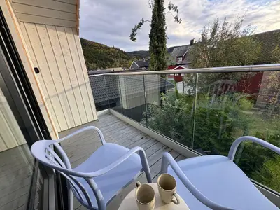 two chairs and a table on a balcony with a view at Chalet Orkanger - Close to Everything, Far from Ordinary in Orkanger