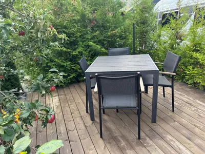 a black table and chairs on a wooden deck at Chalet Orkanger - Close to Everything, Far from Ordinary in Orkanger