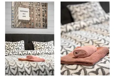 two pictures of a bed with a towel on it at Apartments Bergen free parking in Bergen