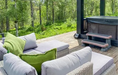 a screened in porch with chairs and a grill at 3 Bedroom Gorgeous Home In Molde in Molde
