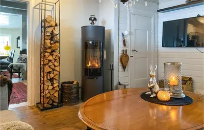 a living room with a table with a fireplace at 3 Bedroom Gorgeous Home In Molde in Molde