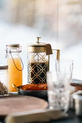 a table with a jar of food and a glass at Ådalsvollen Retreat in Verdal