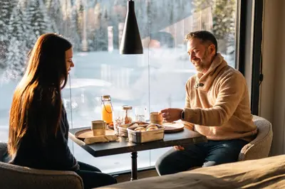a man and a woman sitting at a table with food at Ådalsvollen Retreat in Verdal