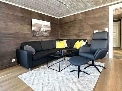 a living room with a couch and two chairs at Lovise Mountain Apartment in Stranda
