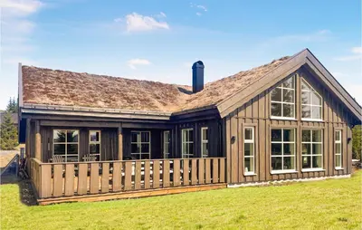a house with a gambrel roof at Amazing Home In Øyer With Sauna in Øyer