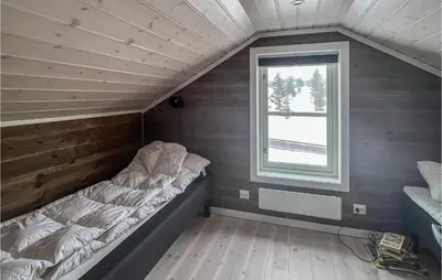 a bed in a small room with a window at Amazing Home In Øyer With Sauna in Øyer