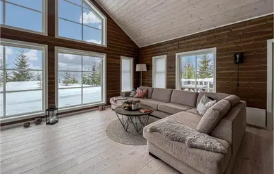 a living room with a couch and a table at Amazing Home In Øyer With Sauna in Øyer