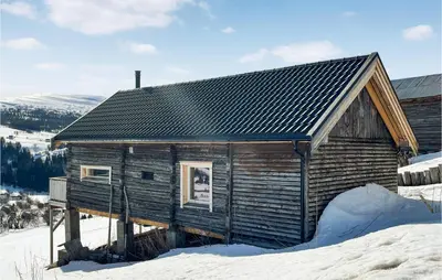 a wooden cabin in the snow in the snow at Stunning Home In Ålen in Ålen