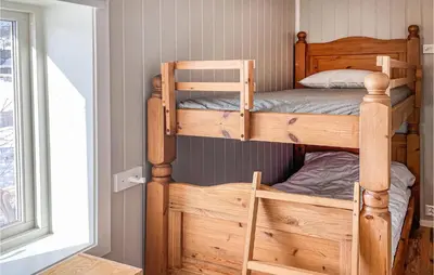 a bedroom with two bunk beds in a room at Stunning Home In Ålen in Ålen