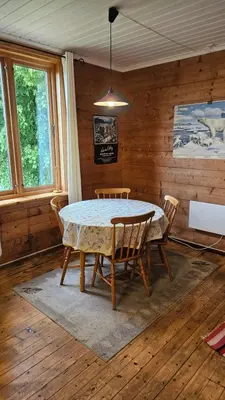 a dining room with a table and chairs at Leilighet v Hardangerfjorden in Hesthamar