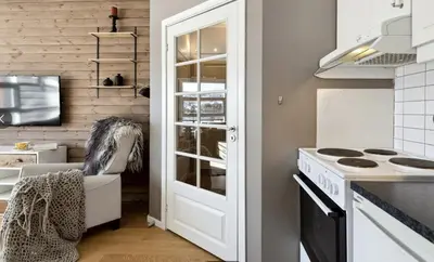 a kitchen with a white door and a stove at Geilo sentrum for 4 personer in Geilo