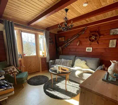 a living room with a couch and a table at Secluded Holiday Home, With private beach in Ålesund