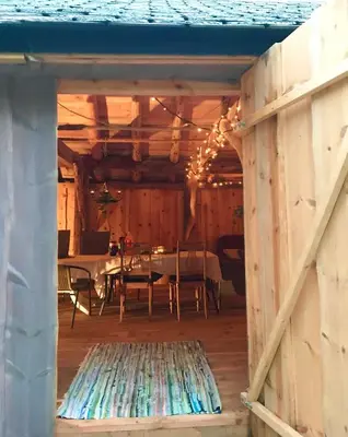 a dining room with a table and chairs and a wooden floor at Secluded Holiday Home, With private beach in Ålesund