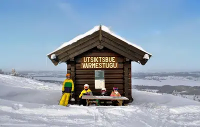 a group of people standing in front of a cabin in the snow at Stunning Home In Gol With Sauna in Gol